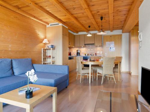 雷克罗塞Apartment Sundance 9 by Interhome的客厅里有一张蓝色的沙发和一张桌子