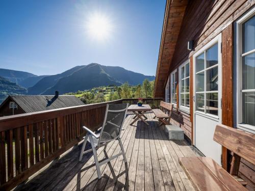 a wooden deck with a table and chairs on it at Holiday Home Frigg by Interhome in Arnefjord