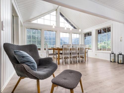 a living room with a chair and a table at Holiday Home Odin by Interhome in Arnefjord
