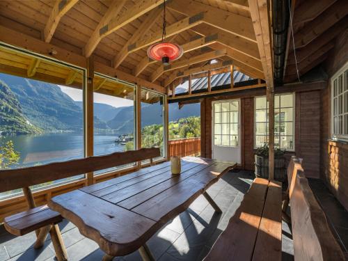a wooden table in a room with a view of a lake at Holiday Home Odin by Interhome in Arnefjord