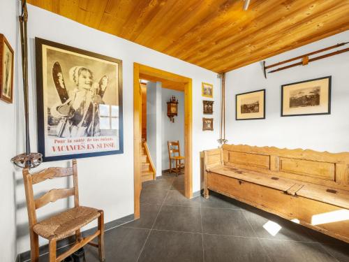 a room with a bench and a poster on the wall at Chalet Godfrey by Interhome in Les Crosets