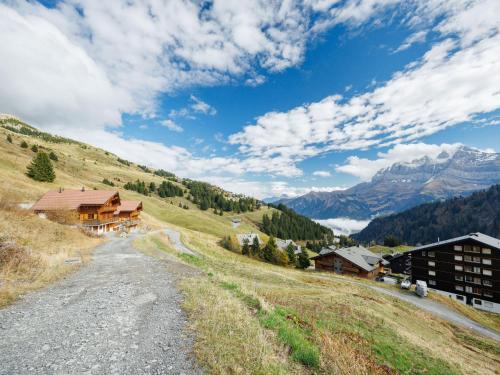 a dirt road leading up to a mountain with buildings at Chalet Godfrey by Interhome in Les Crosets