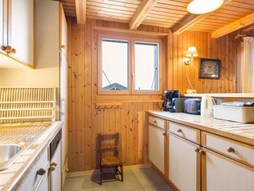 a kitchen with wood paneling and a window at Chalet Chalet Seravalle by Interhome in Les Crosets