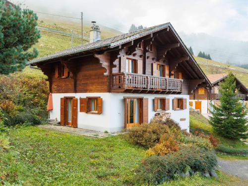 a wooden house with a balcony on a hill at Chalet Chalet Seravalle by Interhome in Les Crosets