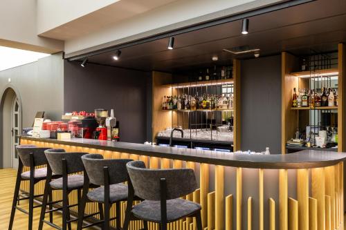 a bar with stools in a restaurant at Kamengrad Hotel & SPA in Panagyurishte