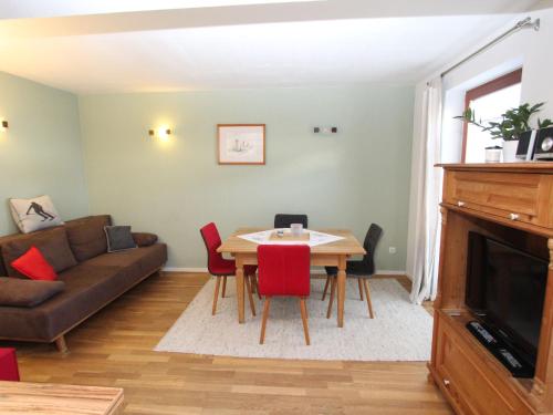 a living room with a table and a couch at Apartment Genner by Interhome in Kitzbühel