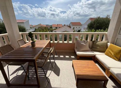 a patio with a table and a couch on a balcony at Villa Lulu in Orebić