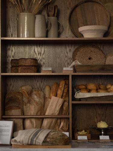 a shelf filled with lots of different types of bread at Elite Hotel Arcadia in Stockholm