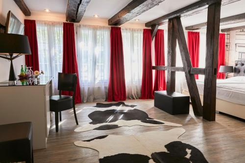 a bedroom with a cow rug on the floor at Hotel im Haus zur Hanse in Braunschweig