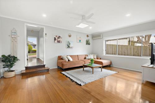 a living room with a couch and a table at Avenue Delight in Rosebud