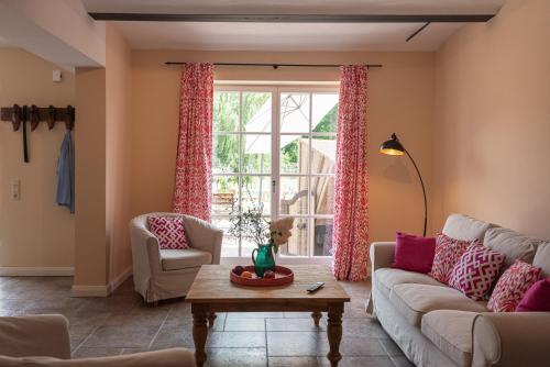 a living room with a couch and a table at Storchenhof Blumenow in Blumenow