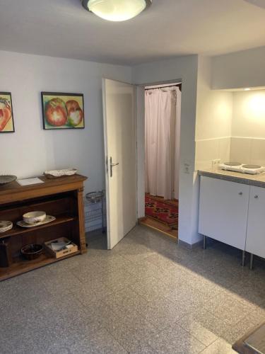 a room with a kitchen with a counter and a door at Schönenborn in Lindlar
