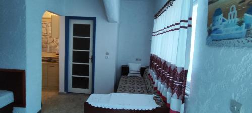 a room with a hallway with a door and a wall at Oleander's Garden Traditional Cretan Cottage in Ferma