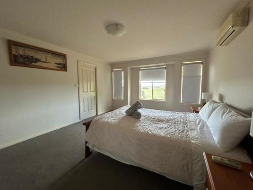 a bedroom with a bed and two windows at Country Paradise Estate in Hall