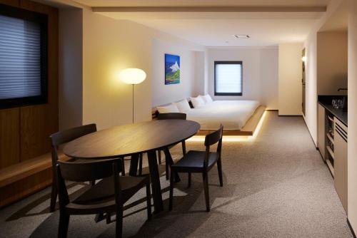 a hotel room with a bed and a table and chairs at Minn Asakusa Kuramae North in Tokyo