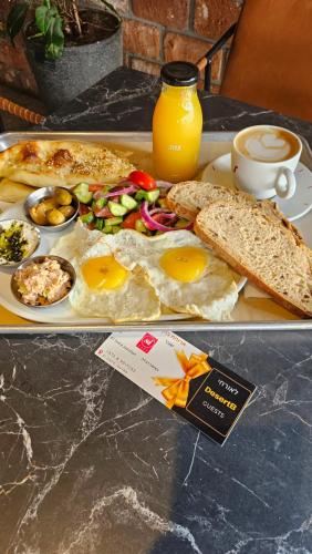 a tray of food with eggs and bread on a table at DesertB in Giv'ot Bar
