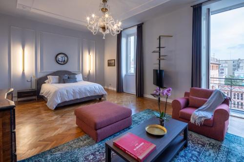 a bedroom with a bed and a living room at Migliori Collection Suites Via Veneto in Rome