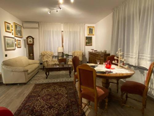 a living room with a table and a couch at B&B casa Orsingher a 2 passi da Belluno in Trichiana