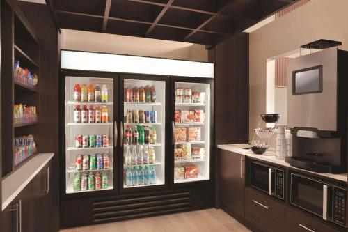 a refrigerator filled with lots of drinks in a kitchen at Radisson Hotel Charlotte Airport in Charlotte