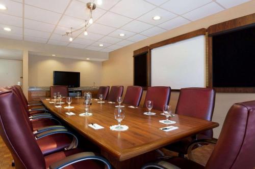a conference room with a long wooden table and chairs at Radisson Akron-Fairlawn Copley in Fairlawn