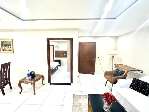 a living room with a couch and a table at Mukhtar Homes Bahria Town Lahore in Lahore