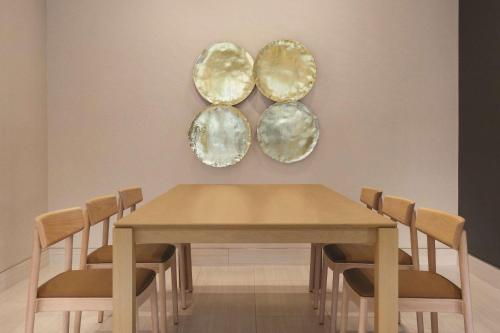 a dining room table with chairs and plates on the wall at Radisson Hotel Seattle Airport in SeaTac
