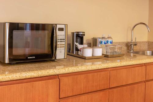 a kitchen counter with a microwave and a sink at Radisson Hotel Panama Canal in Panama City