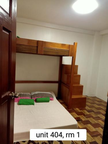 a bedroom with a bunk bed with two green pillows at 017 Baguio Transient in Baguio