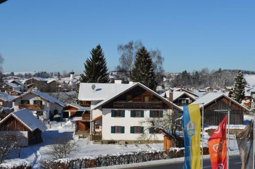 a view of a snowy village with houses at Alpchalet Schwanstein in Halblech