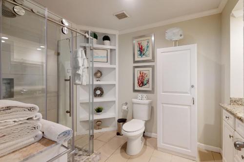 a bathroom with a toilet and a glass shower at Unsearchable Colony V in Port Aransas