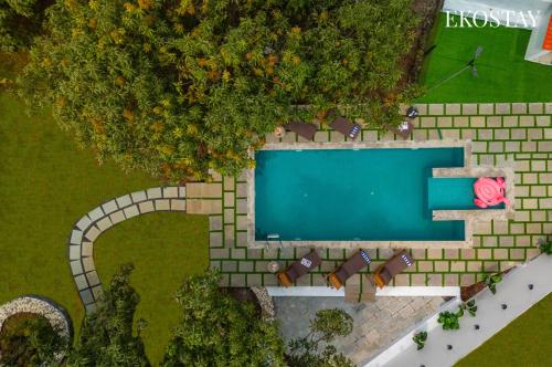 an overhead view of a swimming pool in a park at EKOSTAY - Amanta Palms 6BHK in Karjat