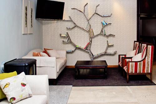 a living room with two couches and a table at Umthunzi Hotel and Conference in Umtentweni