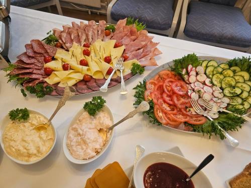 a table with many different types of food on it at Eides Hotel in Høyanger