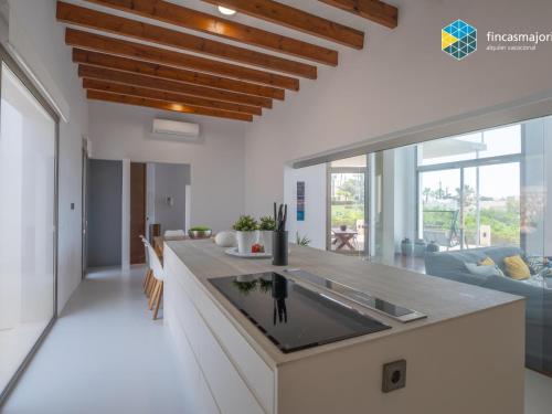 a kitchen with a large island in a house at Sa cova blanca in Cala Pi