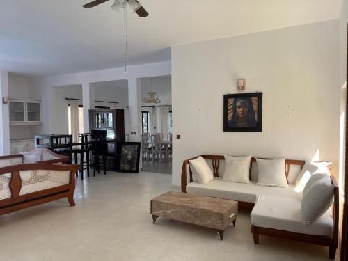 a living room with a couch and a table at Mawe Zuri Resort in Watamu