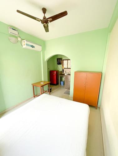 a bedroom with a bed and a ceiling fan at Jolene's Mandrem in Mandrem
