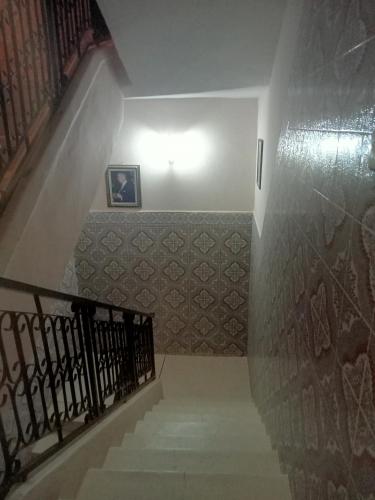 a stairway with a stair railing and a stair case at Maison d'hôtes afoulki tafraout in Tafraoute
