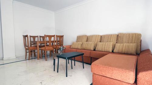 a living room with a couch and a table and chairs at Mshome Sierra Nevada Monachil in Monachil