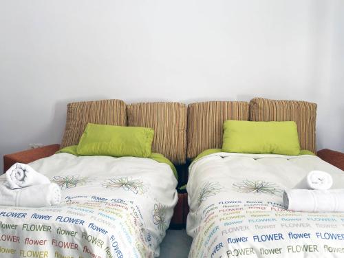 two beds sitting next to each other with towels at Mshome Sierra Nevada Monachil in Monachil