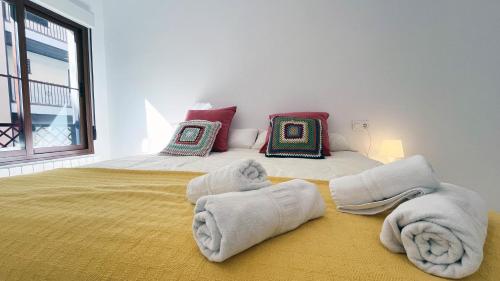 a bedroom with a large bed with towels on it at Mshome Sierra Nevada Monachil in Monachil