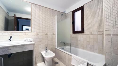 a bathroom with a sink and a tub and a toilet at Mshome Sierra Nevada Monachil in Monachil