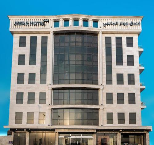 a large building with a sign on top of it at Jiwar Almasi Hotel in Jeddah
