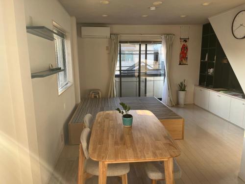 a kitchen and dining room with a wooden table at Shine house warabi in Warabi