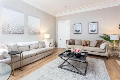 a living room with a couch and a table at The Bradshaw in Prestwick