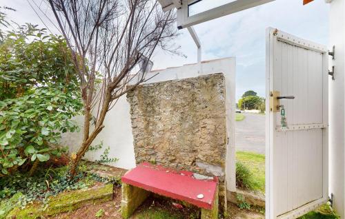 a red bench sitting in front of a white door at Cozy Home In L'épine With Wifi in LʼÉpine