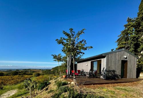 a small house on a hill with a deck at Le Ponant in Vaison-la-Romaine