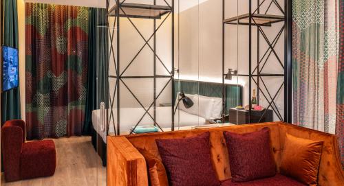 a living room with a couch and a chair at Axel Hotel Bilbao - Adults Only in Bilbao