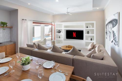 a living room with a couch and a table at Two Bedroom Villa with Outdoor Pool in Umalas
