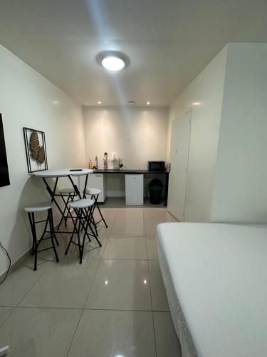 une pièce avec une cuisine avec une table et des chaises dans l'établissement Appartement beau livry, à Livry-Gargan