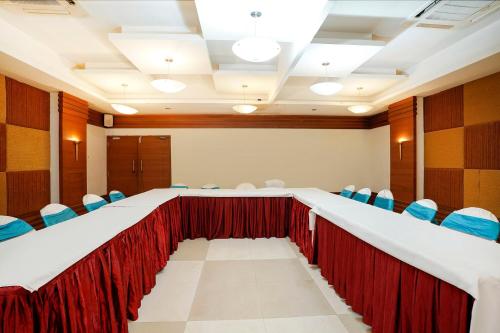 a conference room with a long table and chairs at The Sky Comfort, Ahmedabad in Ahmedabad